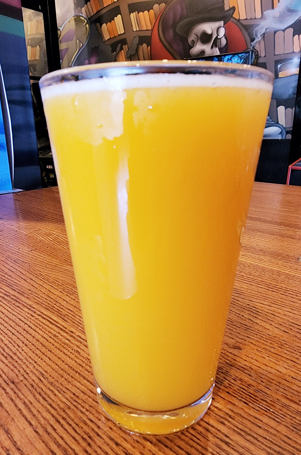 Feelin Easy #2 Sour Ale w/ Strawberry Brewed at Lovedraft's Brewing Co In Mechanicsburg Pennsylvania Perched in front of several pinball and arcade machines at the Lovedraft's brewhouse